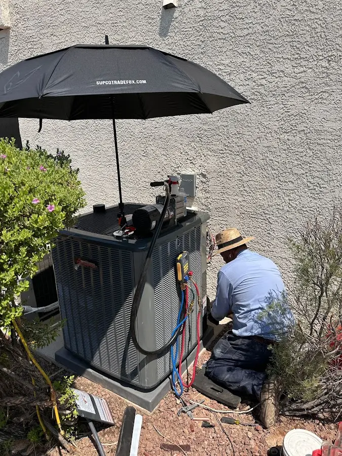 HVAC technician performing outdoor AC maintenance in Kiryas Joel